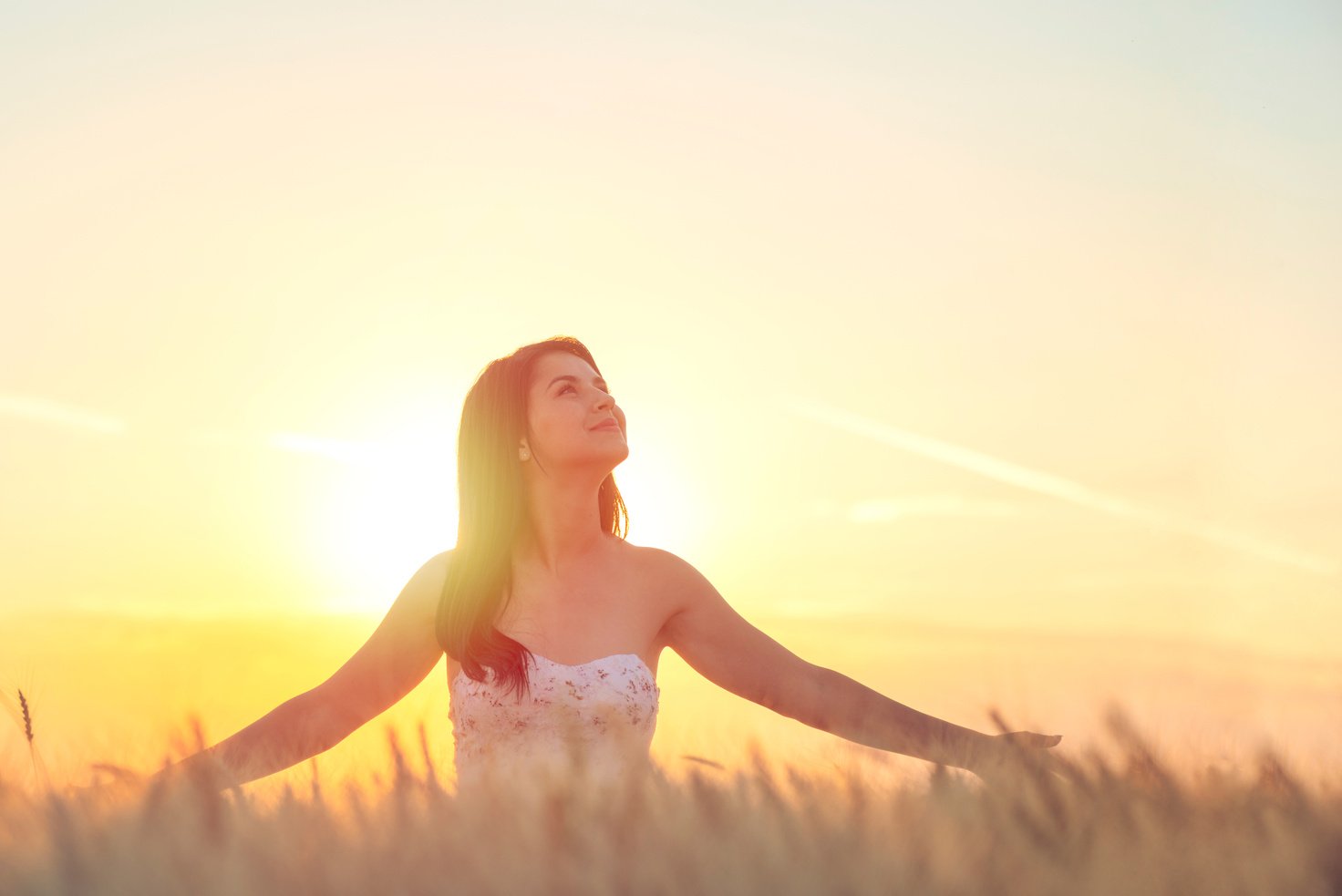 Young woman looking up into the sky.